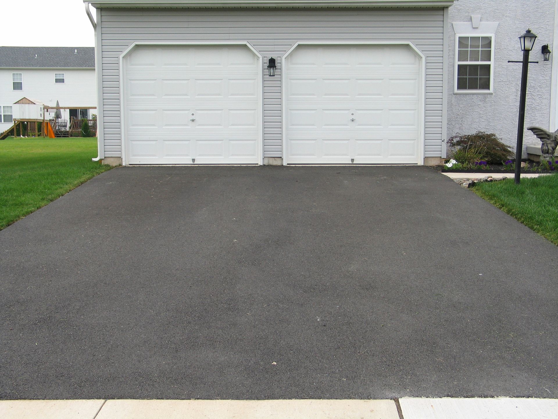 Driveway from a residential asphalt sealcoating service in Syracuse, NY.