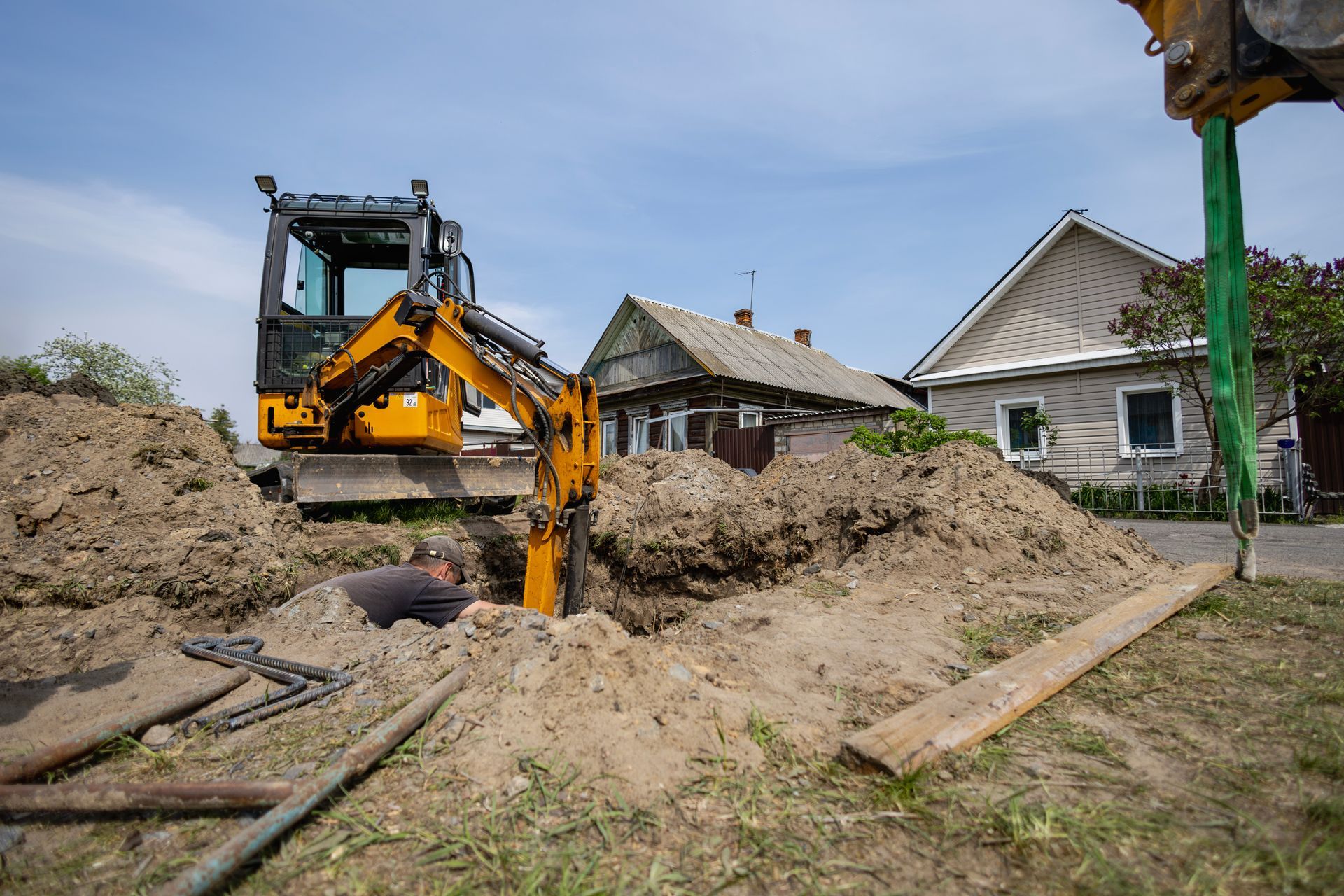 Excavator digging a trench for underground utility or pipeline installation.