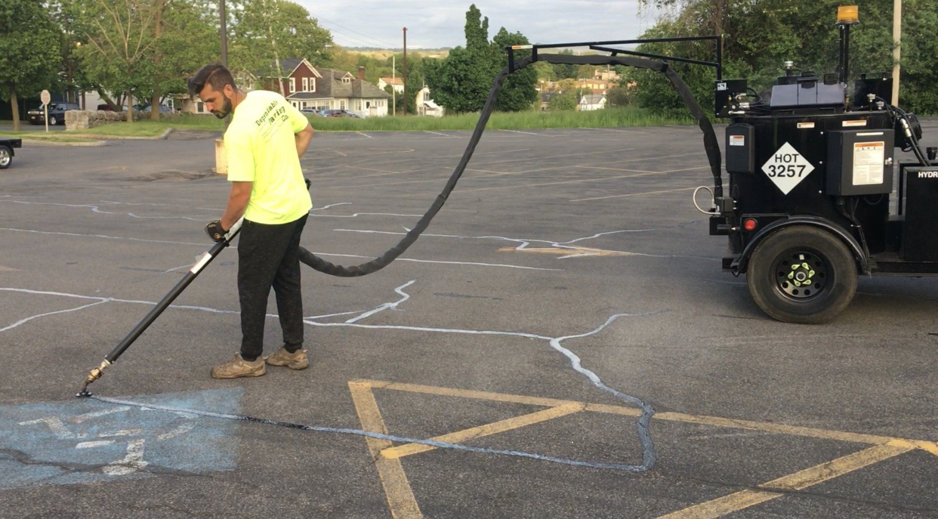 A professional doing residential asphalt sealcoating services in Syracuse, NY.